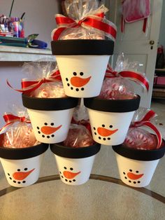 cups filled with hot chocolates and wrapped in red ribbon are stacked on top of each other