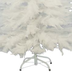 white ostrich feathers are on a stand