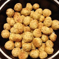 a bowl filled with cooked potatoes sitting on top of a stove