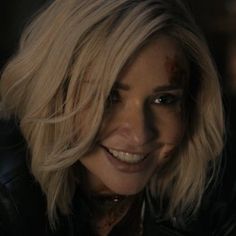 a woman with blonde hair and black leather jacket