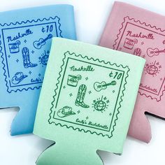 three different colored envelopes with stamps on the front and one in blue, pink, and green