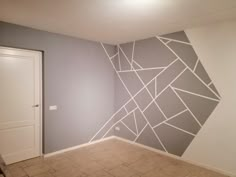 an empty room with a painted wall in the middle and tile flooring on the other side