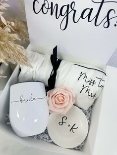 a white box filled with personalized wedding gifts