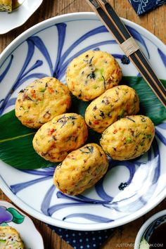 several muffins on a plate with chopsticks