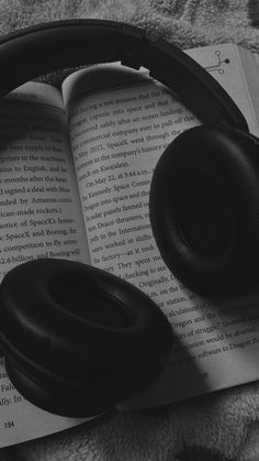 headphones resting on top of an open book