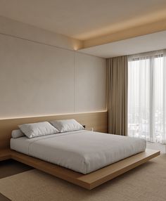 a large white bed sitting in a bedroom next to a tall wooden headboard and window