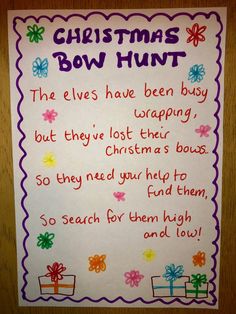 a christmas bow hunt sign hanging on the wall in front of a bulletin board with writing