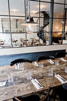 an empty restaurant with wooden tables and chairs