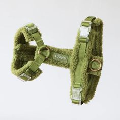 a green dog harness with the words furba written on it's front and back