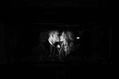 a man and woman are kissing in the dark