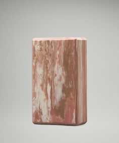 a pink marble block sitting on top of a table