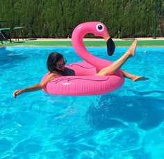 a woman floating on an inflatable flamingo pool float