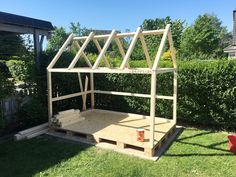 a wooden structure sitting in the middle of a yard