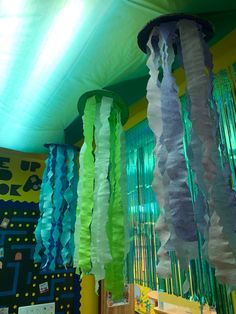 some colorful streamers hanging from the ceiling in a room with green and yellow walls