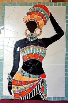 a painting on the wall of a woman with an afro hairdow wearing a colorful dress