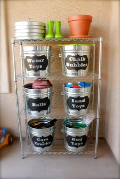 a metal shelf with buckets and cups on it