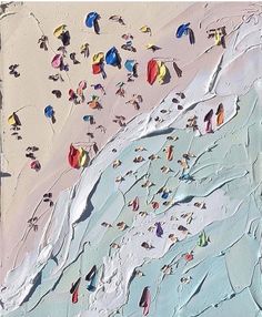 this is an aerial view of people on the beach and in the water with umbrellas