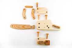 four wooden pegs, one with a saw and the other with holes in them