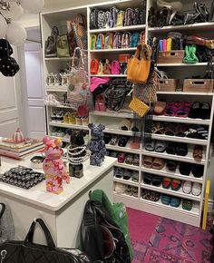 a room filled with lots of purses and handbags on top of white shelves