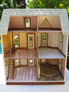 a doll house sitting on top of a table next to a pool