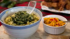 two bowls filled with food sitting on top of a wooden table next to each other