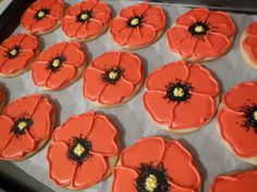 decorated cookies in the shape of poppies on a baking sheet are ready to be baked