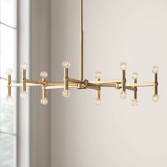 a large brass chandelier with clear glass balls hanging from it's center