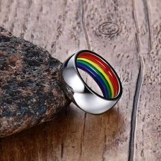 This beautiful ring is the perfect accessory for anyone looking for something much more subtle. The vibrant enamel colors of the rainbow are on the inside of the ring. When it's worn only the beautiful polished stainless steel is visible. This is perfect for anyone who would like a beautifully made piece of pride jewelry even if you're still not out or would like to wear it in a place where people may not know you're LGBTQIA+. You can wear this ring as your little secret and no one will be the w King Ring, Rainbow Ring, Pride Jewellery, Rainbow Rings, Star And Moon, Ring Size Guide, Dress Cuts, Toy Store, Stars And Moon