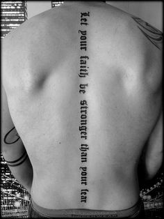 the back of a man's body with words written on it