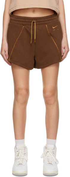 Cotton-blend fleece shorts. Satin piping throughout. · High-rise · Drawstring at elasticized waistband · Two-pocket styling · Logo embroidered at front · Textile logo patch at back Please note that this item may only be shipped within North America. Supplier color: Cacao wow/Ale brown Brown Fitted Sporty Shorts, Brown Athleisure Activewear With Built-in Shorts, Brown Athletic Shorts With Built-in Shorts For Summer, Sporty Brown Bottoms With Built-in Shorts, Nike Cotton Shorts With Moisture-wicking, Nike For Women, Nike Brown, Fear Of God Essentials, Textile Logo