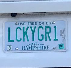 a license plate that reads luckygirl on it's front and back side, with the words live free or die