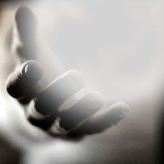 a blurry image of a person's hand holding something