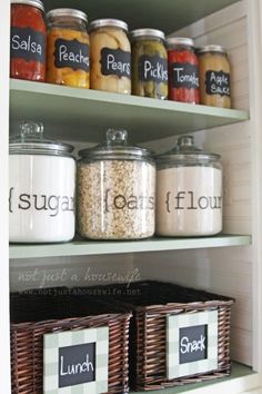 an organized pantry with jars and labels on the shelves, labeled sugar, pears, flour