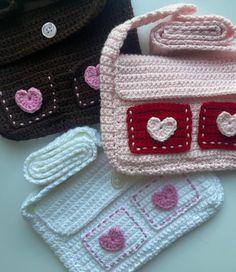 three crocheted purses sitting next to each other on top of a table