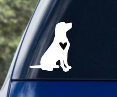 a dog with a heart sticker on the side of a car