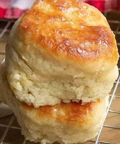 two biscuits stacked on top of each other on a cooling rack in front of an oven