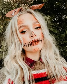 a woman with long blonde hair and makeup is dressed as a skeleton