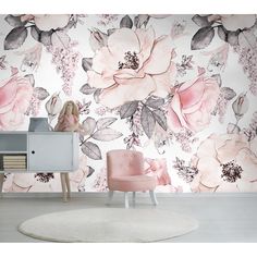 a pink chair sitting in front of a floral wallpapered room with flowers on it