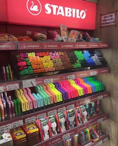 a store display filled with lots of different colored crayons and other items in front of it