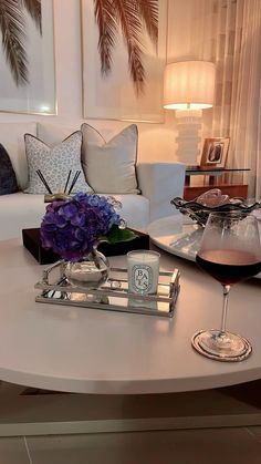 a living room with a couch, coffee table and vase on the center table in front of it