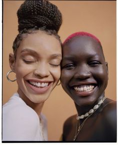 two smiling women with their eyes closed