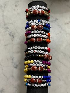 What team do you cheer for? 🏈🏟️ Set of 3 bracelets, 7in long.  -Clemson -Penn State -Georgia -LSU 1st bracelet- name of school spelled out  2nd bracelet- football term or mascot 3rd bracelet- football beads (about a size of a dime)  All bracelets will have team colors or gold beads. -Faceted beads are Acrylic. -Heishi beads are soft clay.  -Gold color beads are copper coated plastic. Personalized Adjustable Bracelets For Team Events, Personalized Bracelets For Team Spirit, Personalized Beaded Bracelets For Team Events, Personalized Multicolor Bracelets For Team Spirit, Adjustable Personalized Bracelets For Team Events, Team Spirit Personalized Bracelets For Game Day, Personalized Team-colored Bracelets For Team Spirit, Personalized Adjustable Team Spirit Stretch Bracelet, Personalized Adjustable Beaded Bracelets For Football Season