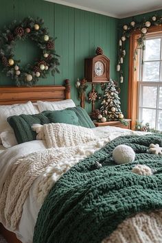 a bedroom decorated for christmas with green walls and white bedding, wreaths on the wall