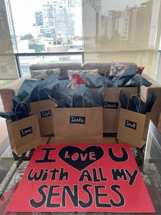 i love you with all my sense bags on display in front of a large window