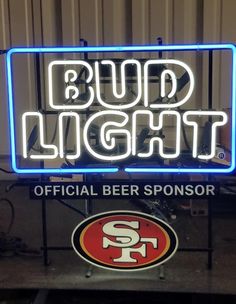 a neon sign that says bud light and a san francisco giants logo on the side