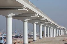 an overpass is being built on the side of a highway