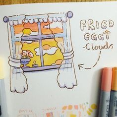 a drawing of a window with the words fried egg clouds on it and two crayons next to it