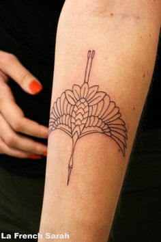 a woman's arm with a flower tattoo on the left side of her arm