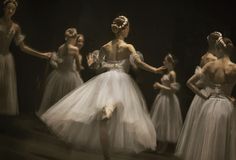 several ballerinas in white tulle skirts and headbands are dancing together