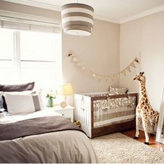 a baby's room with a giraffe statue in the corner